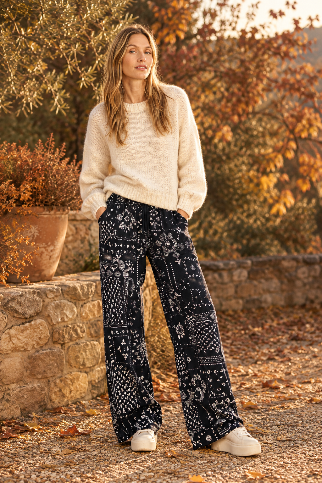 Autumnal outfit with printed trousers, cream jumper and platform trainers