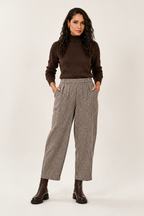 Checked trousers styled with a chocolate-brown roll neck and chunky boots