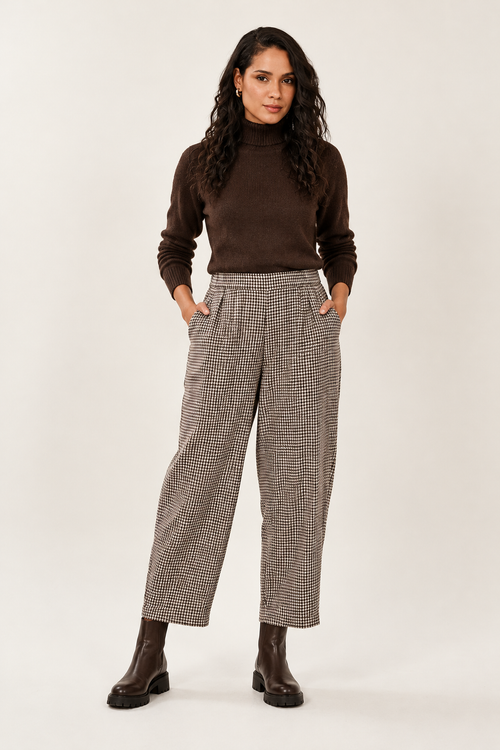 Checked trousers styled with a chocolate-brown roll neck and chunky boots