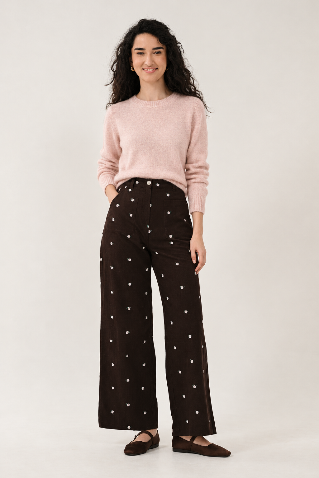 Chocolate wide-leg trousers styled with a pale pink knit jumper
