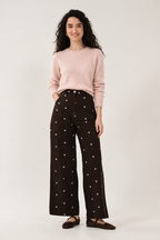 Chocolate wide-leg trousers styled with a pale pink knit jumper