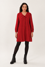 Red dress styled with black tights and black platform ankle boots